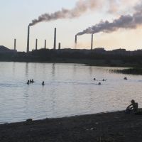 Swimmers in Lake Balkhash with Smoke Stacks in the Background, Балхаш