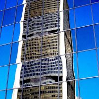 Downtown Montreal - Abstract, distorted image of a building reflected in the windows of a tall city building in downtown Montreal., Монреаль
