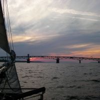 VIRGINIA: YORKTOWN: sunset beyond the George Preston Coleman Memorial Bridge in 2009, from aboard the three-masted schooner Alliance in the York River, Йорктаун