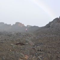 2014-05-01 A hiker by some ancient lava fissure under rainbow., Канеоха