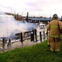Boat Fire, Columbia River. The fire department sprays foam on a burning boat at St. Helens, Oregon., Сант-Хеленс