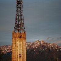 Rain soft water tower at sunset with the Wasatch mountains in the background., Муррей