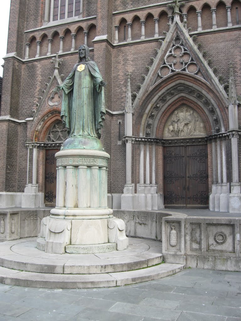 Statue in front of and part of facade Heuvel church, Tilburg, The Netherlands, Тилбург