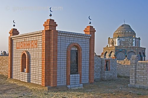 Brick-built Muslim graves and mausoleums in the early morning sunlight., Карабутак