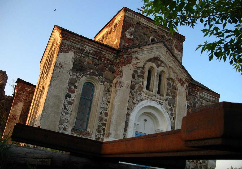 Rusty cross laying near All Saints Ortodox Church in Biahomĺ, Бегомль