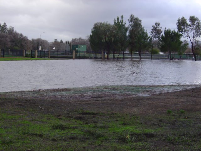 2005 Flood: Drainage Pond in Coast Guard Housing(Victory Village) overfilled pouring out onto Olivera Road, Конкорд
