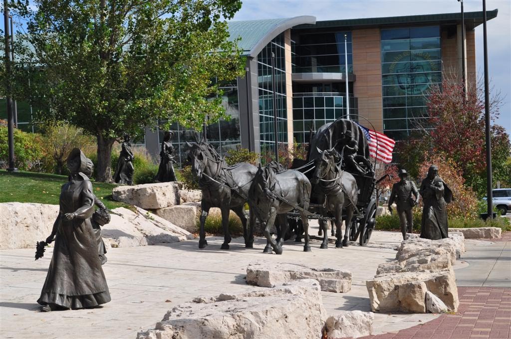 woman walking, wagon pulled by horses, Pioneer Courage, Omaha, NE, Омаха